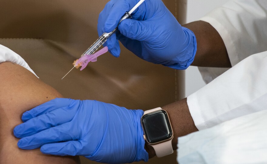 Arlene Ramirez receives the Moderna coronavirus COVID-19 vaccine at Northwell Health's Long Island Jewish Valley Stream hospital in New York City on Dec. 21. Healthcare workers across the country have started receiving COVID-19 vaccines, but doctors and nurses at some hospitals say vaccine distribution has been chaotic.
