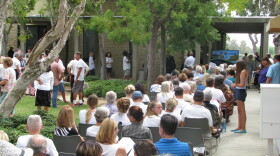 An overflow crowd fills the courtyard outside Carlsbad City Hall, as the City Council votes on a plan to build a shopping center on the shores of the Agua Hedionda Lagoon, Aug. 25, 2015.