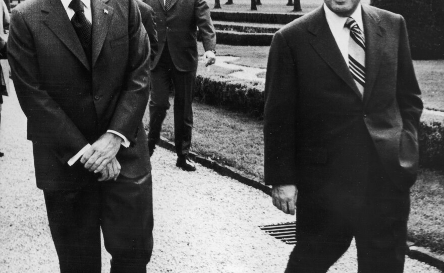 President Nixon walks with U.S. Secretary of State Henry Kissinger in 1972, during peace talks in Paris that were aimed at ending the Vietnam War. A year later, Kissinger was awarded the Nobel Peace Prize for his role in negotiating the ceasefire.