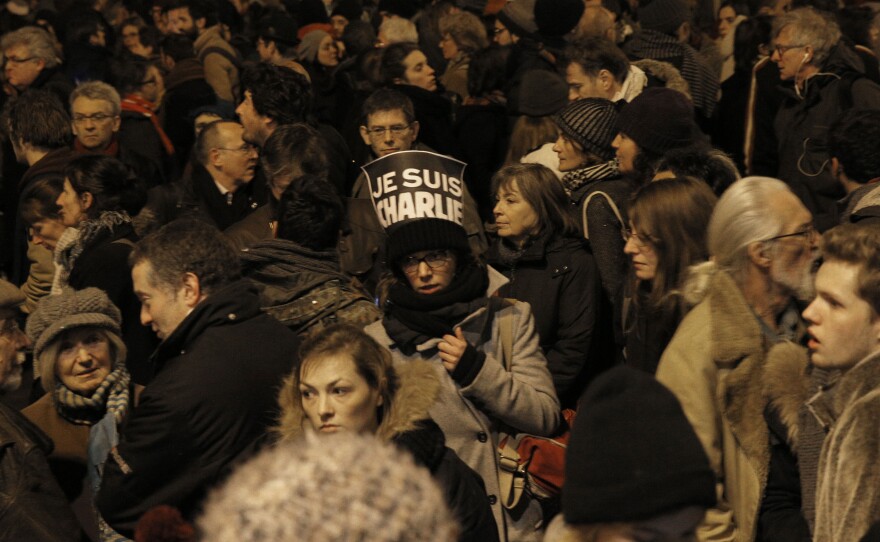 A woman holds a sign reading "I am Charlie" at a demonstration today in Paris following a deadly attack at the offices of Charlie Hebdo, the weekly satirical magazine.