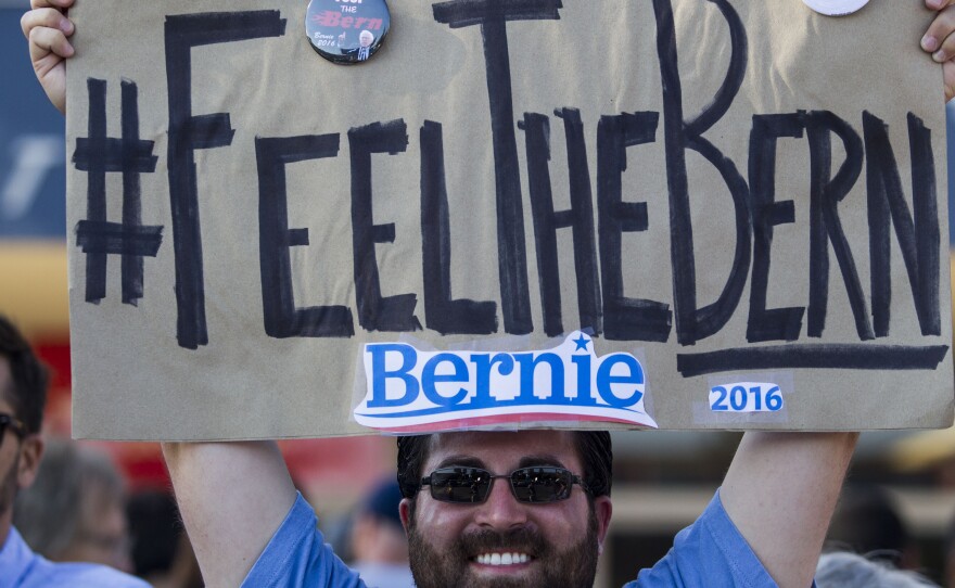 Frank Rothstein holds a "Feel the Bern" sign before a rally Bernie Sanders in Los Angeles that drew tens of thousands. The phrase has become an anti-establishment rallying cry for Sanders fans.