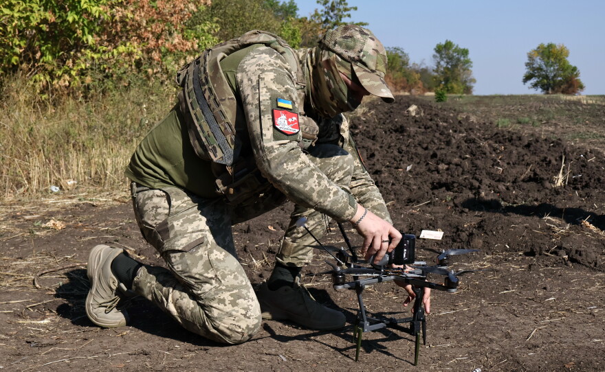 In this photo provided by Ukraine's 65th Mechanized Brigade press service, a Ukrainian soldier prepares an FPV drone to fire towards Russian positions in Zaporizhzhia region, Ukraine, Saturday, Sept. 19, 2026.