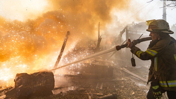 A rescue worker puts out a fire at residential houses destroyed in a Russian strike on Kharkiv, Ukraine, Sunday, Oct. 11, 2026.