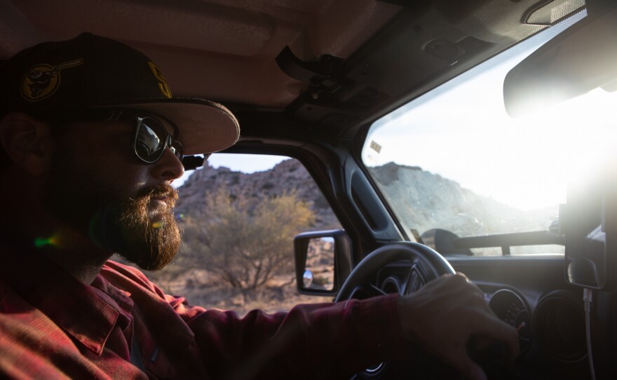 James Cordero of Border Kindness leads a group into the Jacumba Wilderness at sunrise to make drops of water and other supplies for migrants, Aug. 13, 2022. 