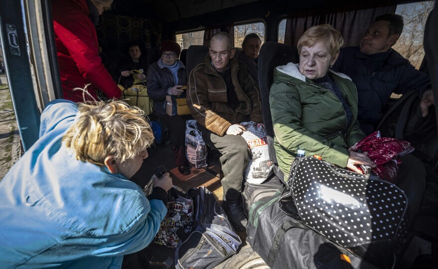 People crowd into a bus on Thursday on their way to a train station in Severodonetsk, as they try to flee eastern Ukraine.