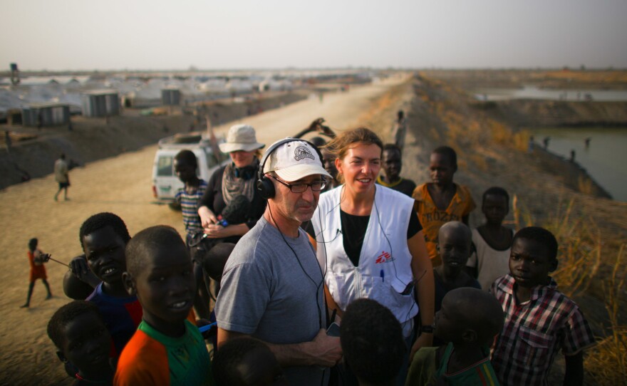 Jason Beaubien talks with Stefania Poggi, who manages the Doctors Without Borders operation. They're standing next to the drainage ponds dug to keep the camp from flooding in rainy season. Kids often jump in for a swim.