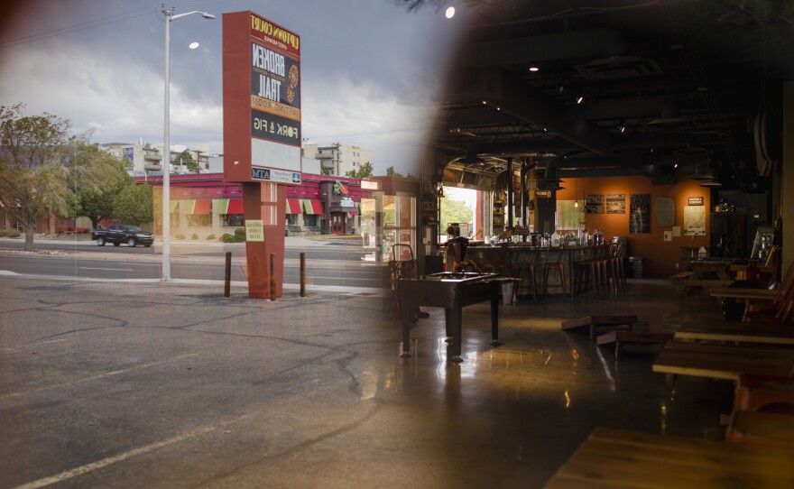 A window reflection through the empty inside of Broken Trail Distillery & Brewery in Albuquerque, N.M. Matt Simonds is the owner and has struggling to keep his business afloat since pandemic lockdown orders were issued in March.
