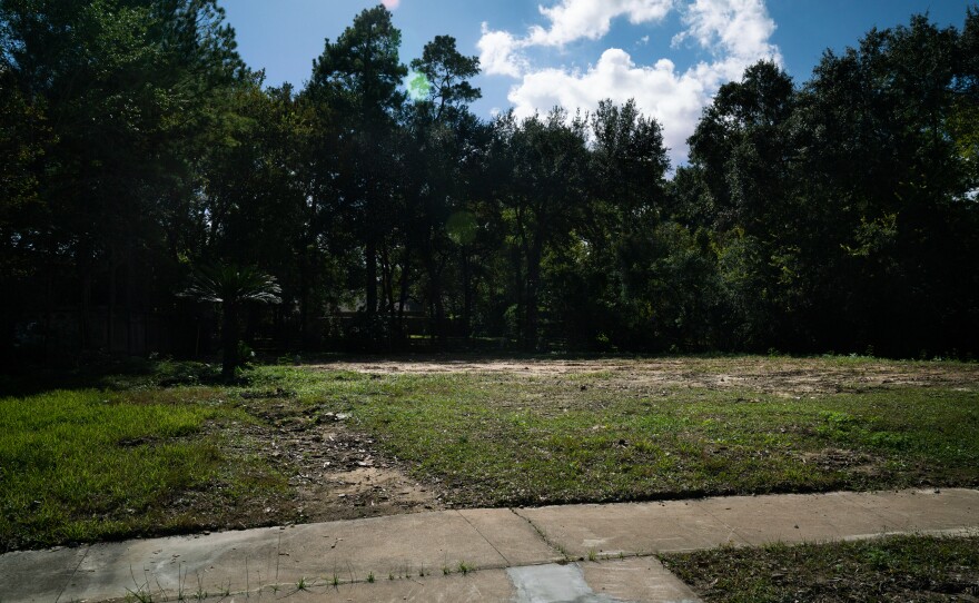 The empty lot of land where John and Heather Papadopoulos' home once stood on Bayou Glen Road.