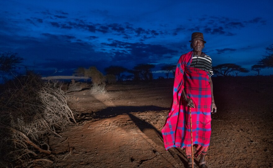 Samburu elder Francis Lengees stands near his home. In the late 1970s, he and fellow herders helped build the first structures for the primary school that Paris and his two moran "brothers" now attend.