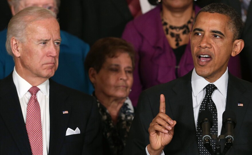 Vice President Biden looks on as President Obama speaks at the White House.