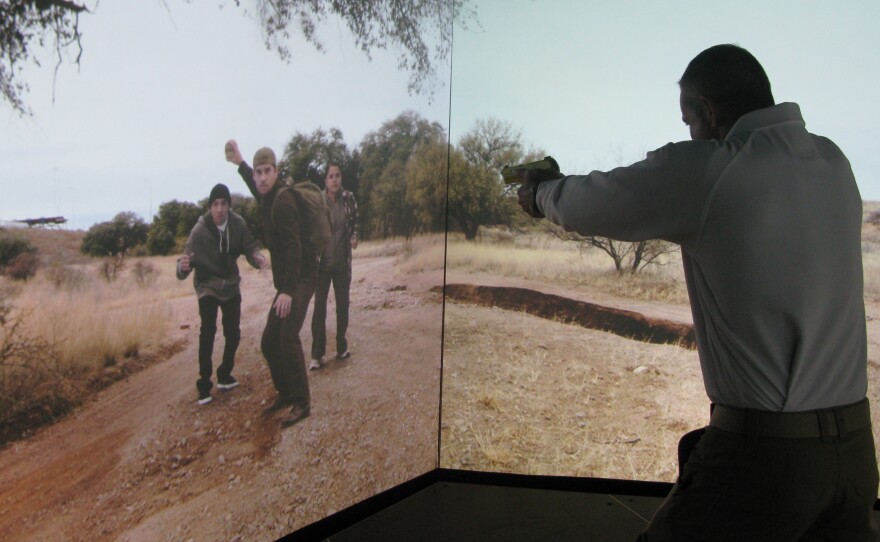 In order to reduce shootings, all Border Patrol agents are now required to train in a simulated environment complete with immigrants threatening rocks. Agent Aaron Sims trains on the simulator at the CBP National Training Center in Harper's Ferry, W.V.