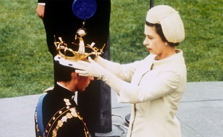 Queen Elizabeth II formally investing her son Prince Charles with the Coronet of the Prince of Wales during an investiture ceremony at Caernarfon castle. Tuesday Sept. 27, 2022.