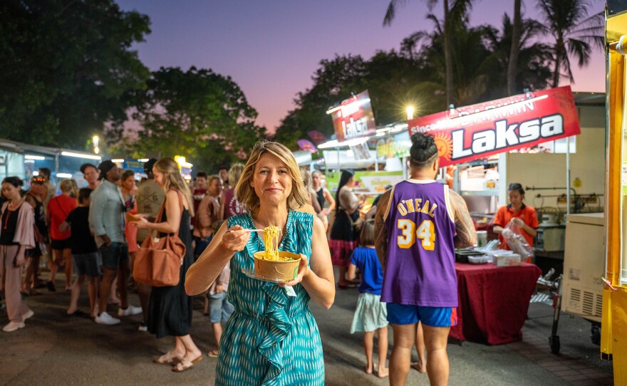 Samantha Brown eating Laksa noodle soup at Mindl Beach night market in Darwin, Australia.