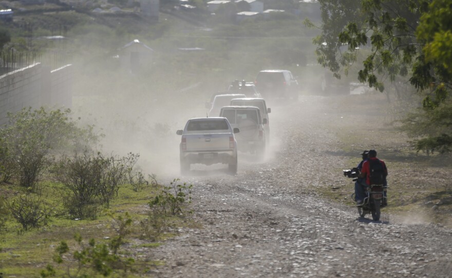 A caravan drives to the airport after departing from the Christian Aid Ministries headquarters at Titanyen, north of Port-au-Prince, Haiti, Dec. 16, 2021.