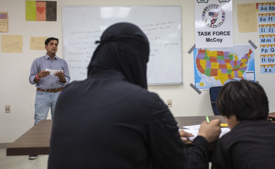 The refugees attend a class at the base.