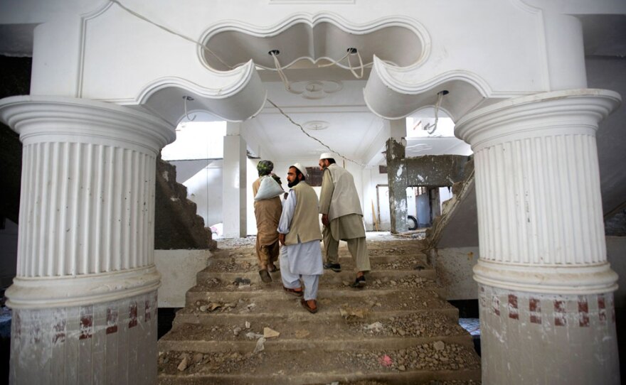 Contractors walk through an apartment complex under construction in downtown Kandahar, Afghanistan, in April.