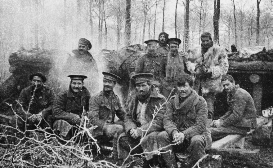 Group of Britain's 1st Battalion London Rifle Brigade just after dinner, at Ploegsteert Wood, Belgium, on Christmas 1914.
