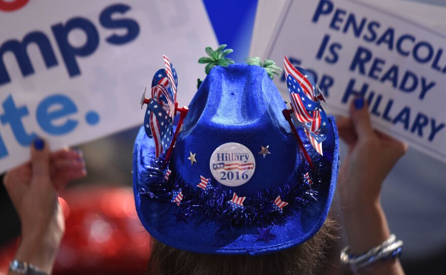 A Hillary Clinton supporter holds up signs on Monday evening.