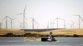 A tug boat pushes a barge down the Sacramento River in the Sacramento-San Joaquin River Delta near Rio Vista,  Sept. 23, 2013. Along with providing a source for commercial transportation and pleasure craft, the delta also provides much of the water for central and southern California cities and irrigation water for San Joaquin Valley farmers. 