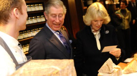 An artisan discusses cheese with Charles, Prince of Wales and The Duchess of Cornwall.