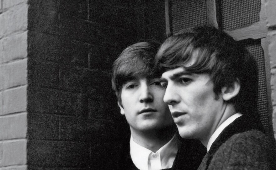 John Lennon and George Harrison, photographed in Paris in 1964.
