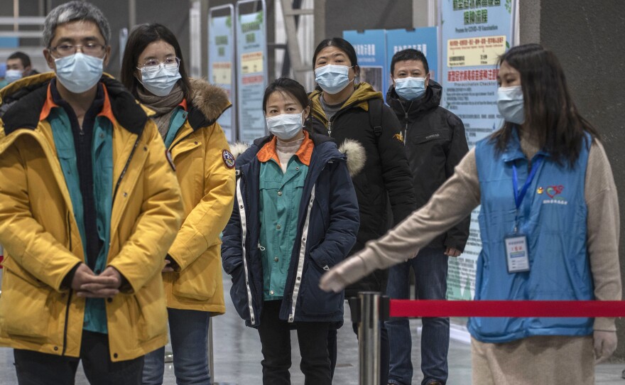 Chinese workers wait to receive a COVID-19 vaccine jab at a mass vaccination center in Beijing on Jan. 5. Even with at least 5 homegrown vaccines nearing approval, China is setting a modest initial goal: 50 million people vaccinated by mid-February — about 3.5% of the total population.