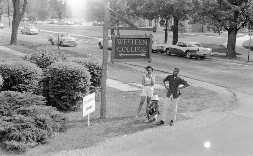 Western College sign with three young people, June 1964