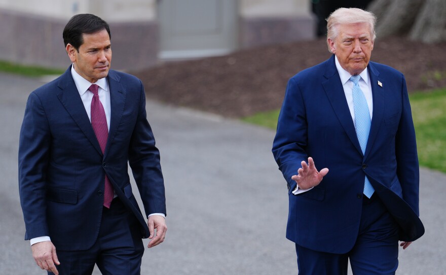 President Donald Trump walks with Secretary of State Marco Rubio to speak with reporters before departing on Marine One from the South Lawn of the White House, Friday, March 20, 2026, in Washington.
