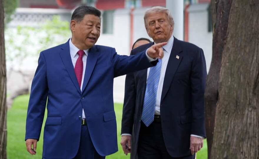 FILE - President Donald Trump talks with China's President Xi Jinping at the Zhongnanhai leadership compound, May 15, 2026, in Beijing.