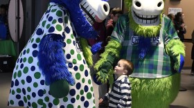 Hartford Yard Goats mascots Chew Chew, left, and Chompers greet a small fan during a game between the Yard Goats and Richmond Flying Squirrels at Dunkin' Donuts Park in Hartford, Conn., on Tuesday, April 16, 2019.