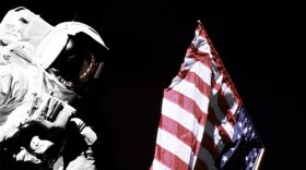 Geologist-Astronaut Harrison Schmitt, Apollo 17 Lunar Module pilot, is photographed next to the American Flag during extravehicular activity (EVA) of NASA's final lunar landing mission in the Apollo series. The photo was taken at the Taurus-Littrow landing site. The highest part of the flag appears to point toward our planet earth in the distant background. 