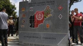 Family members of fallen Marines look for their loved one’s names during the 5th Marine Regiment Operation Enduring Freedom memorial dedication ceremony at Camp Pendleton on June 6, 2013
