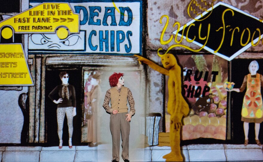 1927's performances feature few actors, but have elaborate, stylized scenes projected on a white sheet behind the actors.