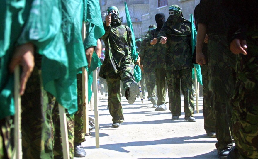 Masked members of Hamas hold Islamic flags during a 2002 march in the Jabalia refugee camp in the Gaza Strip to protest against the U.S. position on Jerusalem.