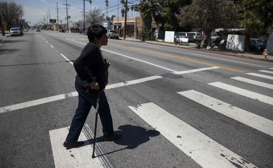 Emma Allen crosses the street in this undated photo near the South Los Angeles senior center where she works as a receptionist as part of a job training program for low-income seniors.