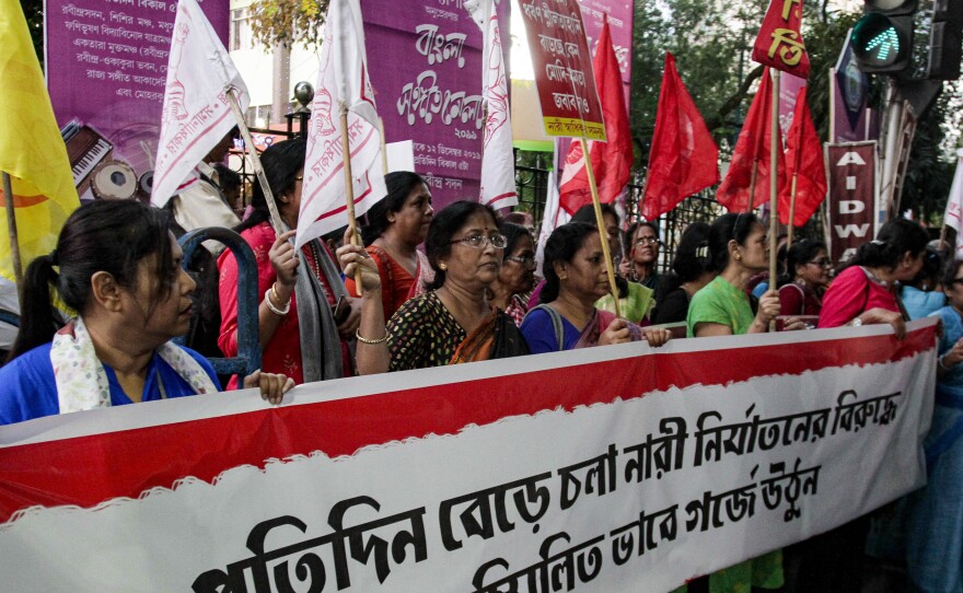 Activists demanding justice in the case of a veterinarian who was gang-raped and killed last week shout slogans during a protest on Thursday in Kolkata, India.