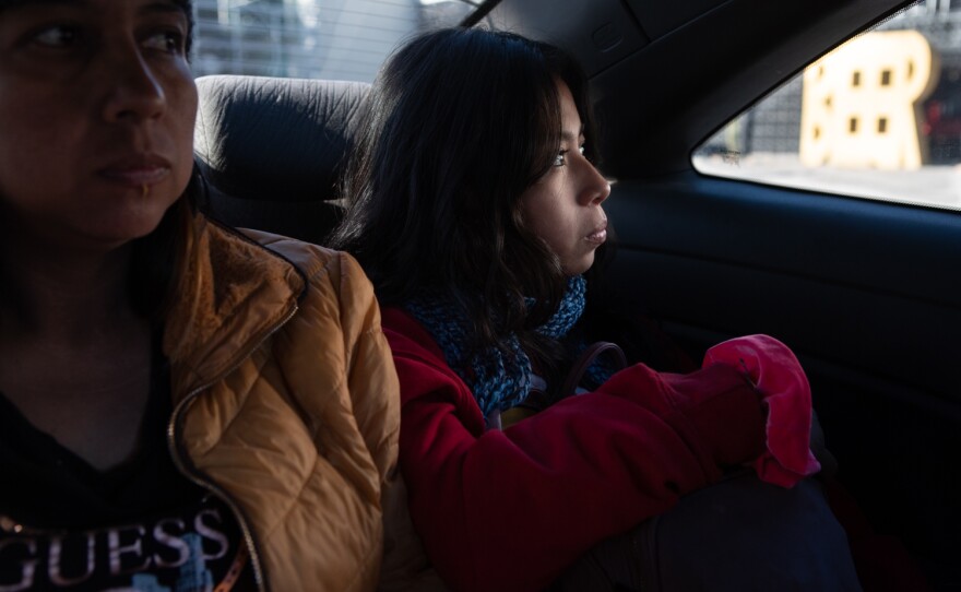 Hazel Lucia Flores Rodriguez looks out the window while driving to receive a COVID-19 test in Tijuana, Dec. 19, 2022.