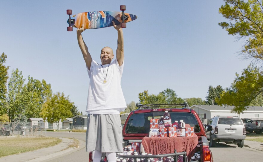 Nathan Apodaca's TikTok video, in which he longboards to Fleetwood Mac's "Dreams," has catapulted him to viral fame. Here, he is standing in the pickup truck given to him by Ocean Spray. In his video, Apodaca sips from a bottle of Ocean Spray's Cran-Raspberry juice.