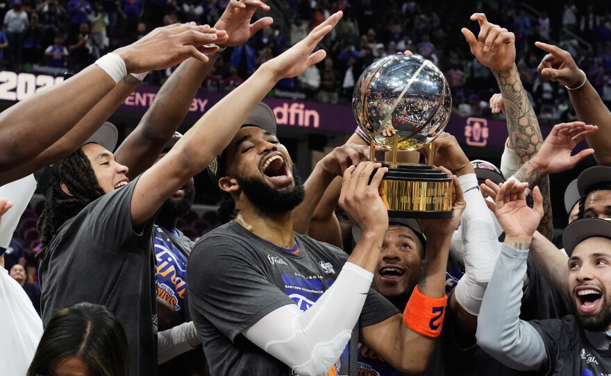 New York Knicks center Karl-Anthony Towns, center, and teammates celebrate after winning Game 4 in the Eastern Conference finals NBA basketball playoffs series against the Cleveland Cavaliers in Cleveland, Monday, May 25, 2026
