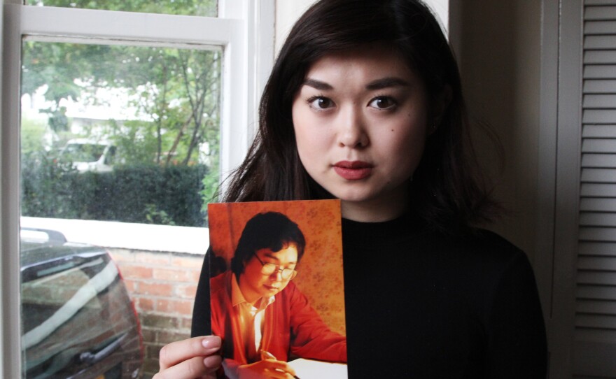 Angela Gui, 22, became a human rights campaigner after her father, Gui Minhai, a Hong Kong bookseller, was put in Chinese detention. She holds a photo of her father at her home in the English Midlands.