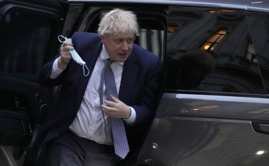 Britain's Prime Minister Boris Johnson arrives back at 10 Downing Street in London, Tuesday, Jan. 25, 2022.
