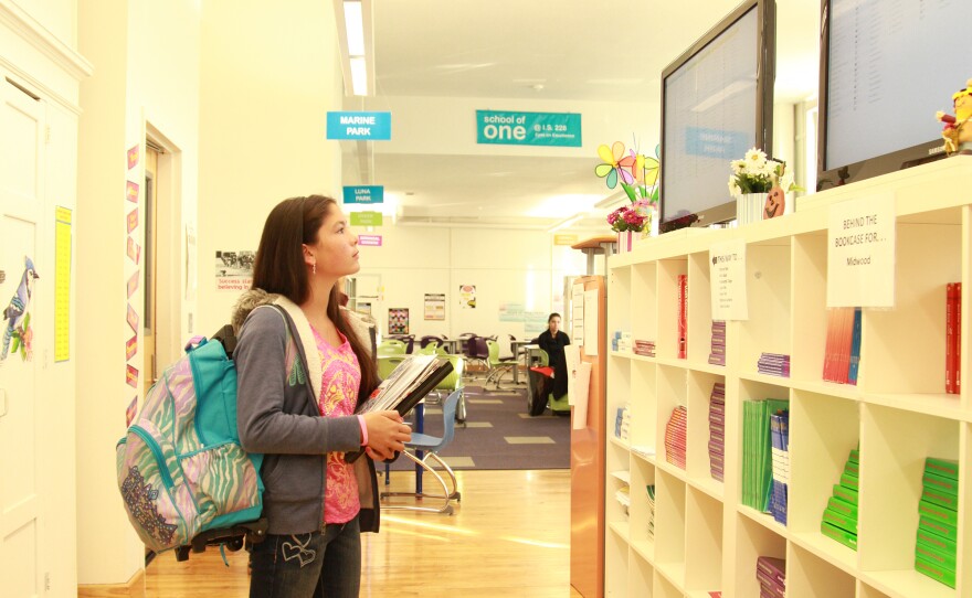 A student checks the assignment screen to find where she is sitting today.