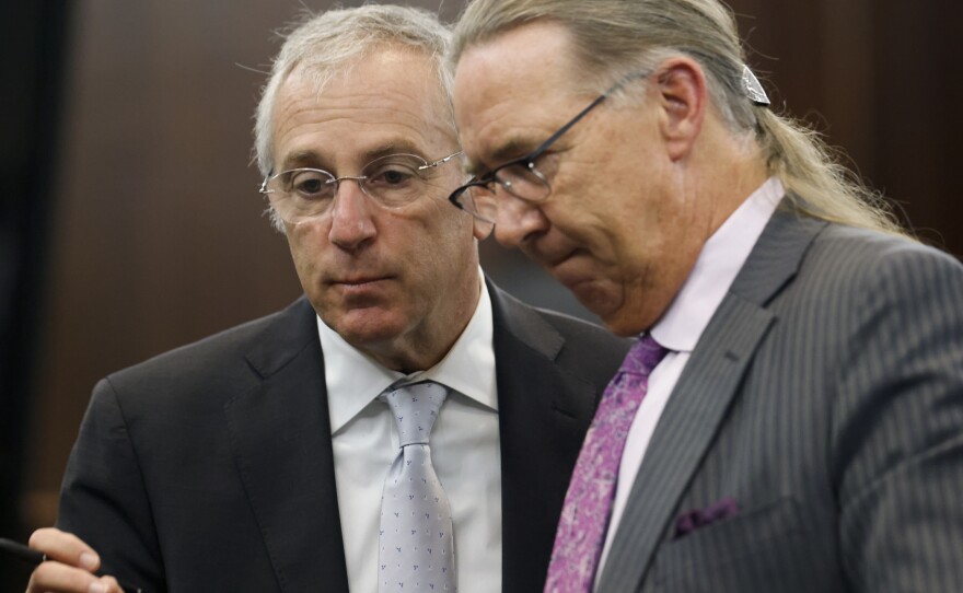 Defense attorneys Franklin Hogue (R) and Robert Rubin talk during jury selection in the trial of the men charged with killing Ahmaud Arbery. Greg and Travis McMichael and their neighbor, William "Roddie" Bryan are charged with the February 2020 slaying of the 25-year-old jogger.