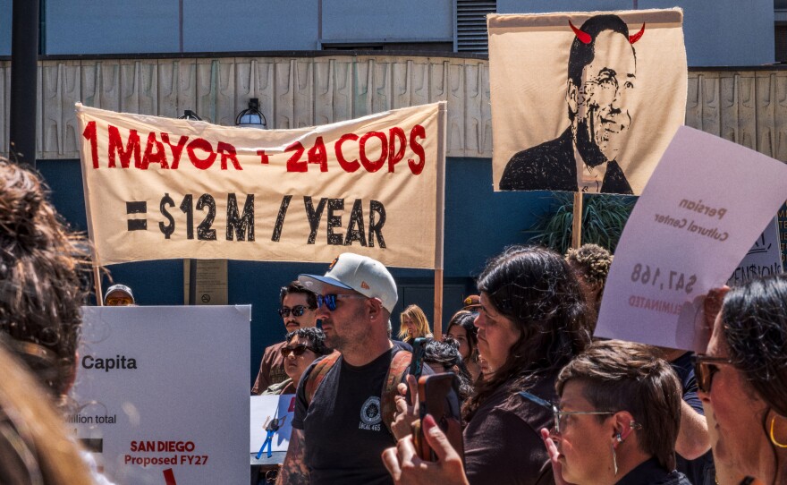 Protesters opposed to San Diego Mayor Todd Gloria's budget cuts to arts programs gather at San Diego's Civic Center Plaza before a City Council meeting on April 20, 2026.