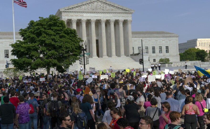 Abortion rights activists protest outside of the U.S. Supreme Court in Washington on May 3, a day after the leak of a draft opinion suggesting a possible reversal of <em>Roe v. Wade. </em>