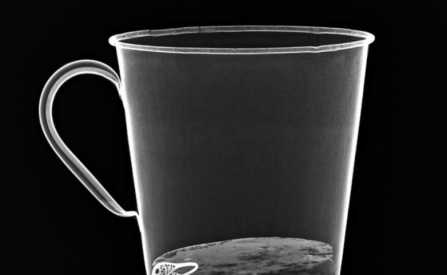 An X-ray reveals the jewelry concealed behind the false bottom, which separated from the mug after more than 70 years.