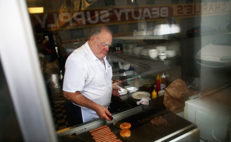 Harlan works the grill at Red Hots Coney Island. A Coney dog should always be grilled, says Joe Grimm, author of Coney Detroit.