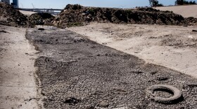 An earthen berm made up of dirt and debris blocks the flow of waster from Mexico into the United States in the Tijuana River, June 14, 2022.