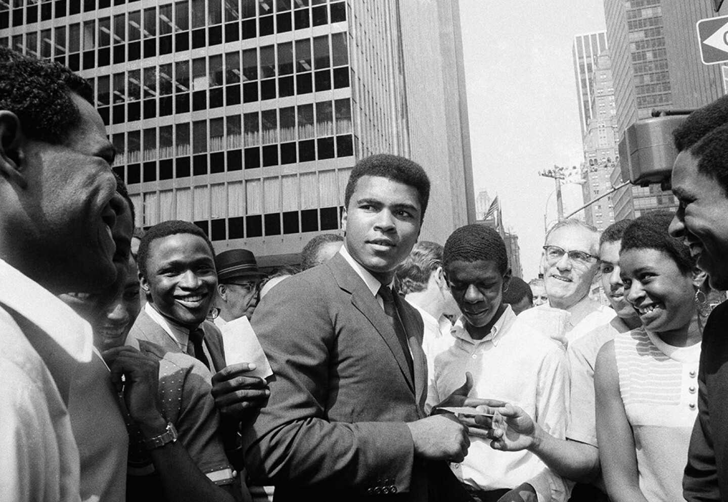 Muhammad Ali, is surrounded by autograph seekers at 51st Street and Sixth Avenue in Manhattan, N.Y. Aug. 23, 1968.
