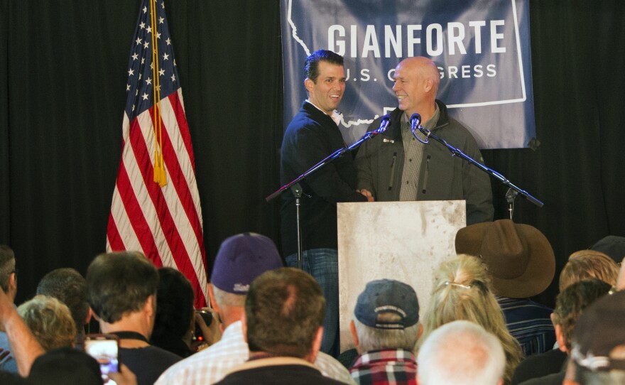 Republican Greg Gianforte (right) welcomes Donald Trump Jr., the president's son, onto the stage at a rally in East Helena, Mont., on May 11. Gianforte, a businessman, is embracing his party's president in his race for the state's open congressional seat.